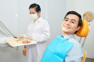 smiling ethnic man in dental chair S6A2NGK